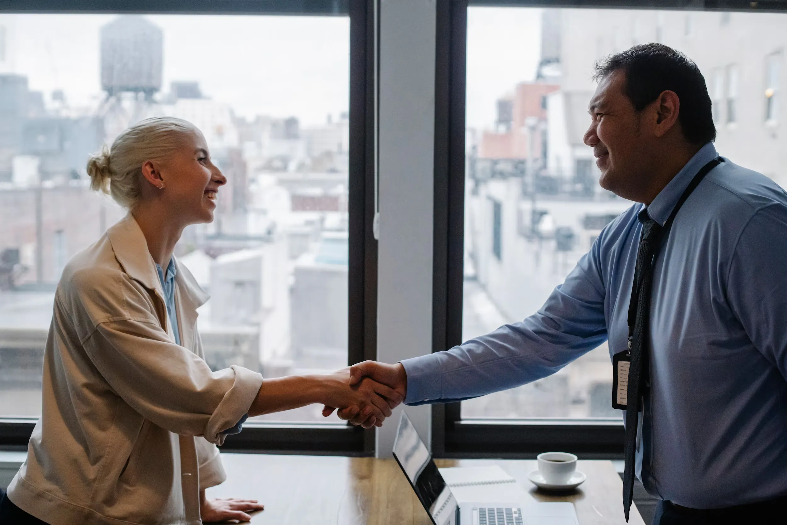 Two business partners shaking hands in an office